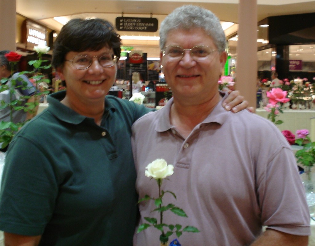 Dr. Monica Valentovic and Dr. Gary Rankin smile together while holding a white rose.