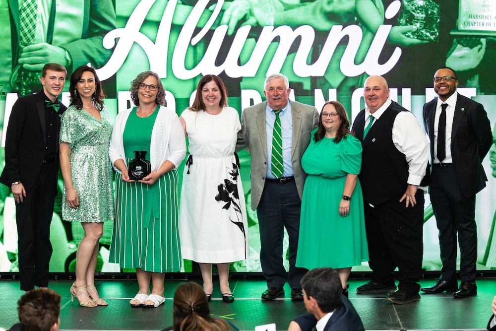 Members of a Marshall University alumni chapter pose with an Alumni Awards recognition during the university's Annual Alumni Awards celebration.