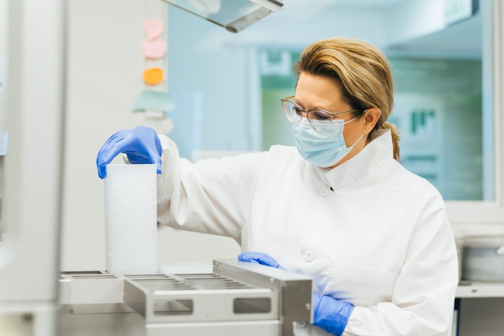 faculty member performing a forensic science test with a mask on
